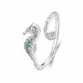 Seahorse ring styled with other silver jewellery