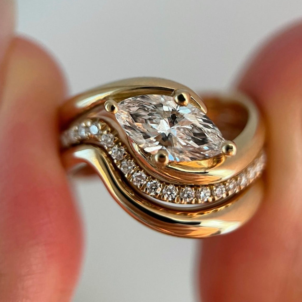 Marquise wave ring set showing three piece moissanite stack