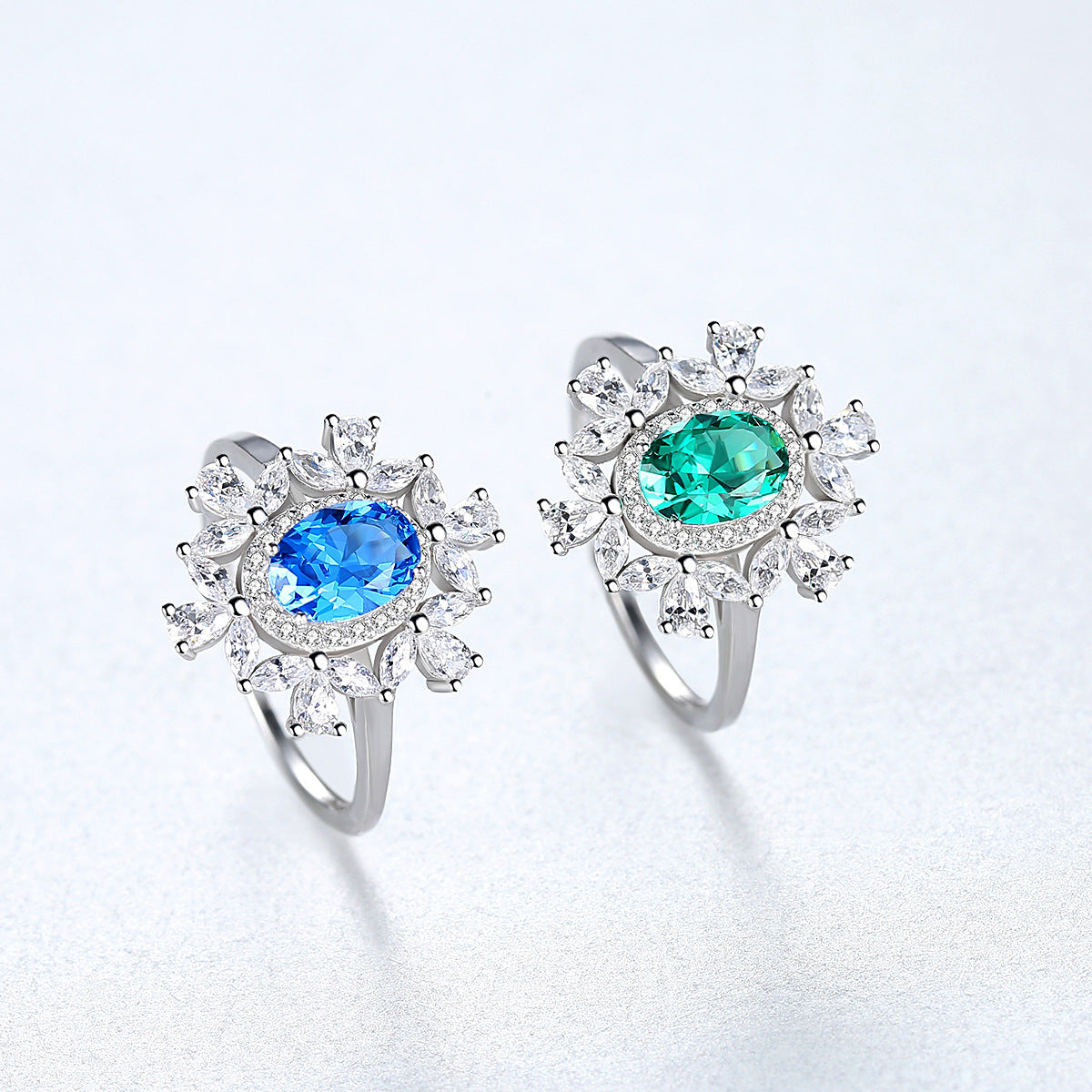 Floral petal ring showing sapphire and emerald options
